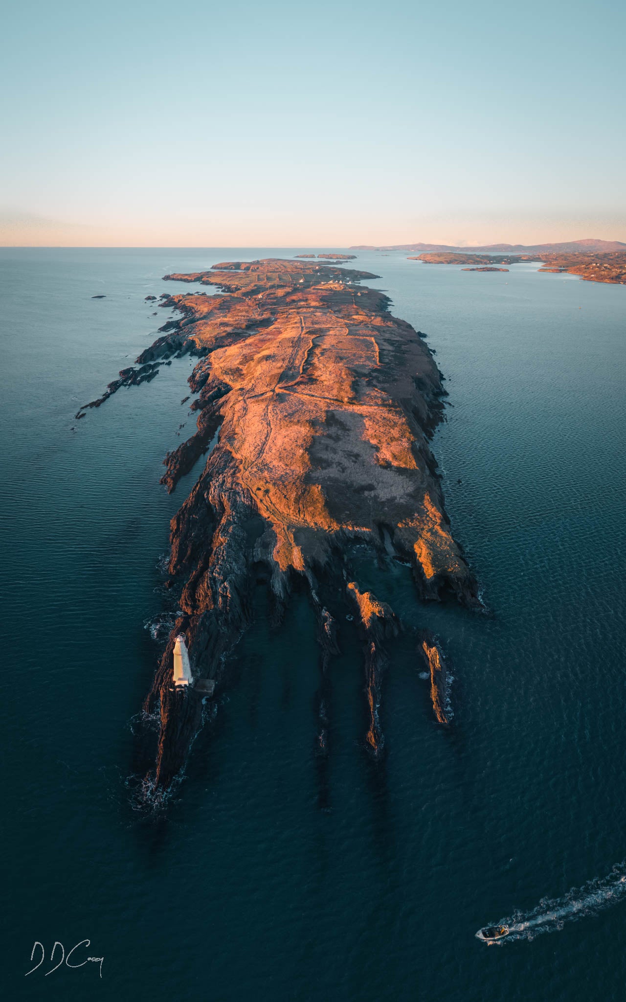 A photo print of Long Island in West Cork, showing the island's rugged coastline and picturesque scenery at sunrise.