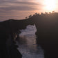 Photo print of wild goats crossing sea arch on Eastern Skeams island, peeking over a stone wall.