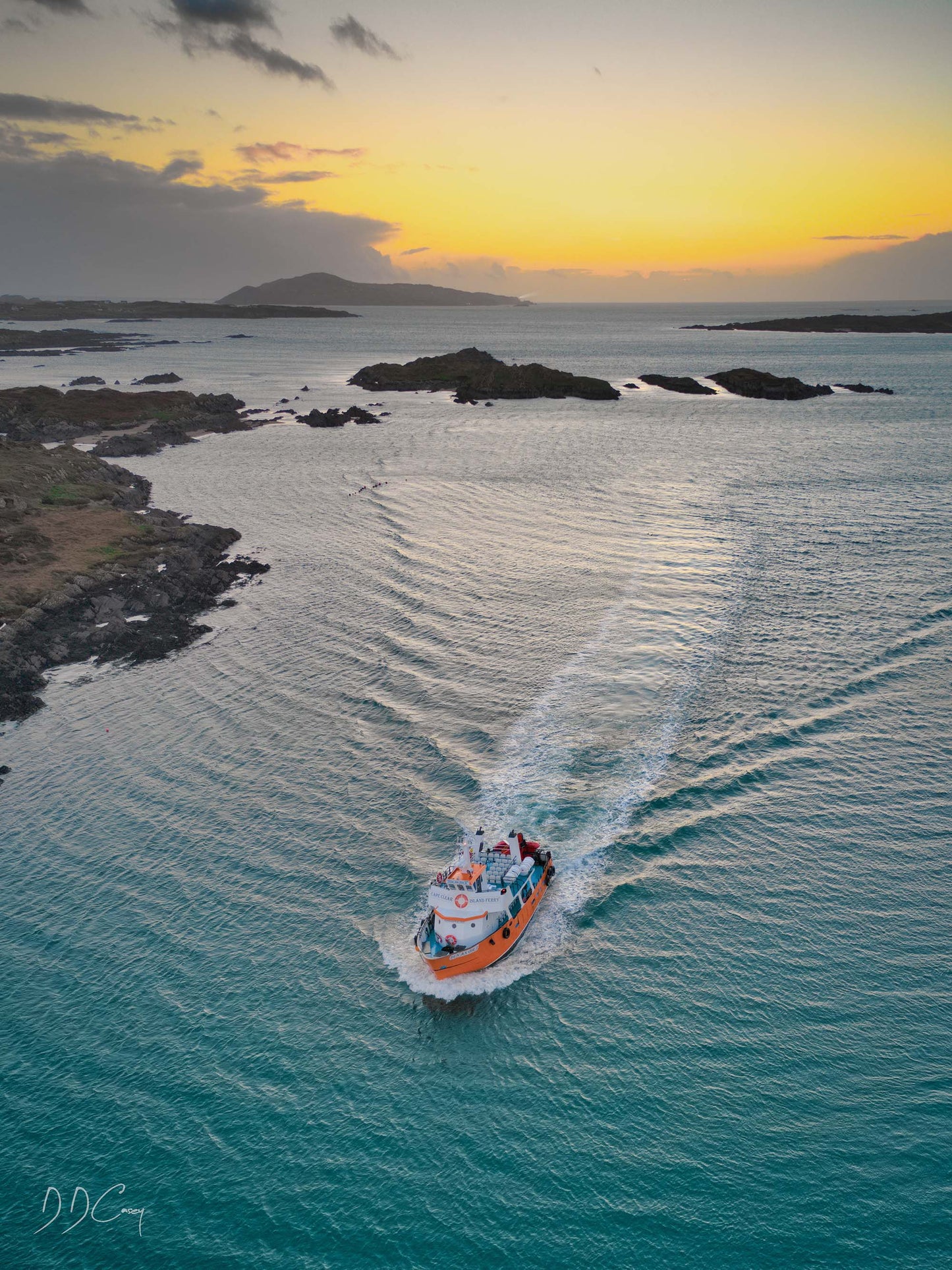 Cape Clear Ferry navigating the Carbery Isles at Turk Head, surrounded by rocky shores providing shelter for the vessel.